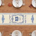 Blue and white memorial table runner with years at the table and quote on a wooden table with plates