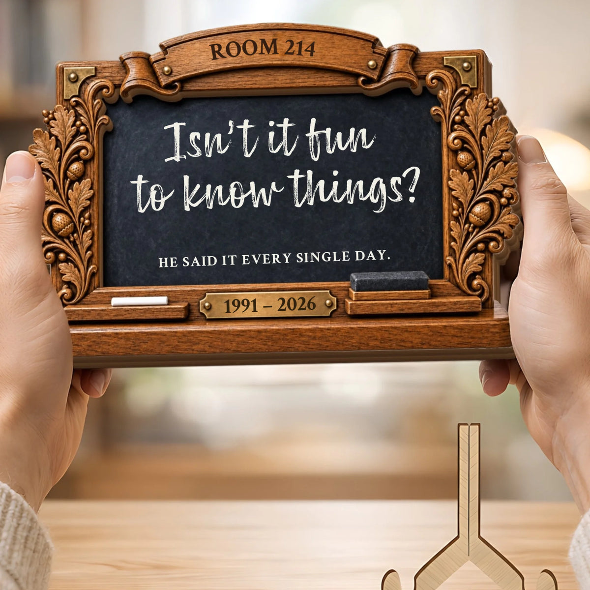 Hands holding personalized teacher memorial chalkboard plaque with carved wooden frame