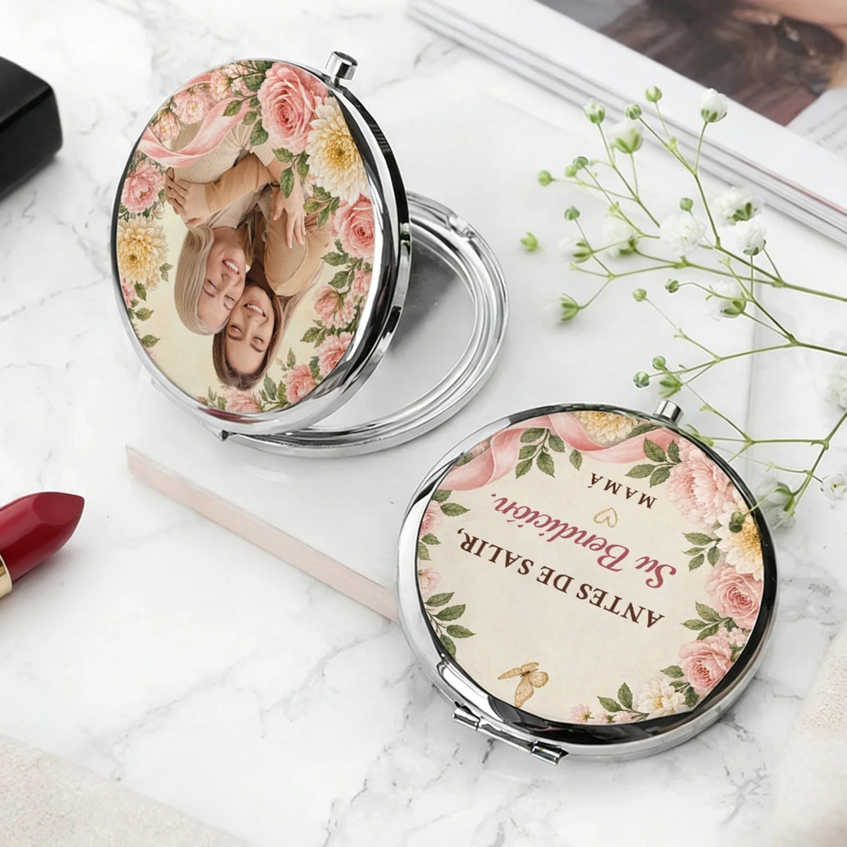 Open silver compact mirror showing photo cover and Spanish blessing back
