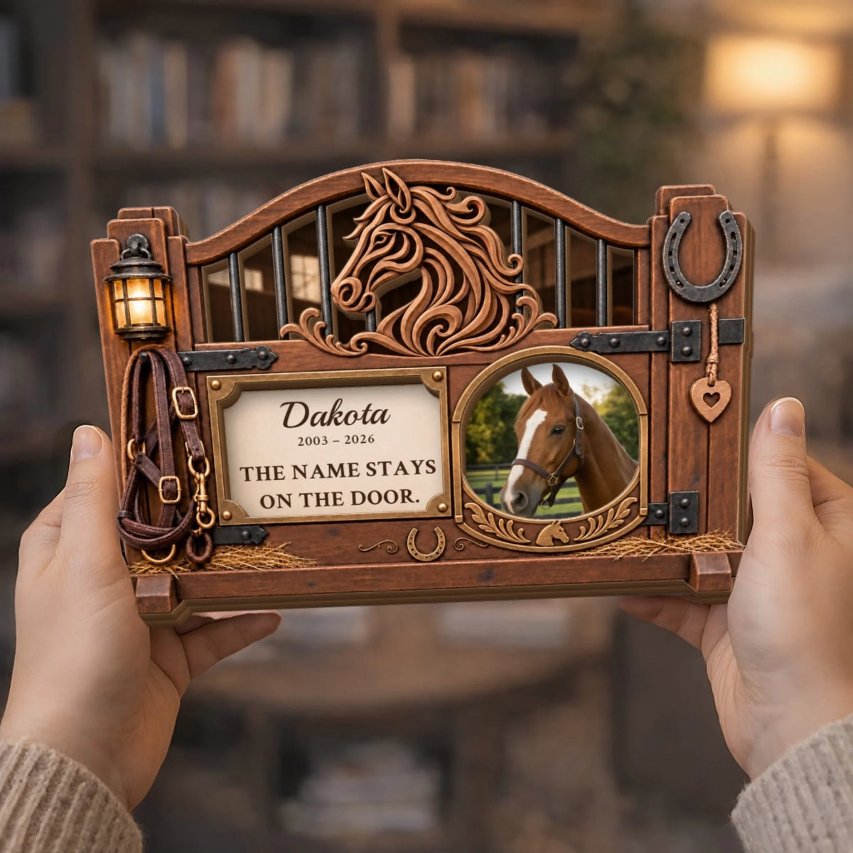 Hands holding horse memorial plaque with name, years and stall door quote