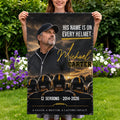 Woman holding coach memorial garden flag reading His Name Is On Every Helmet